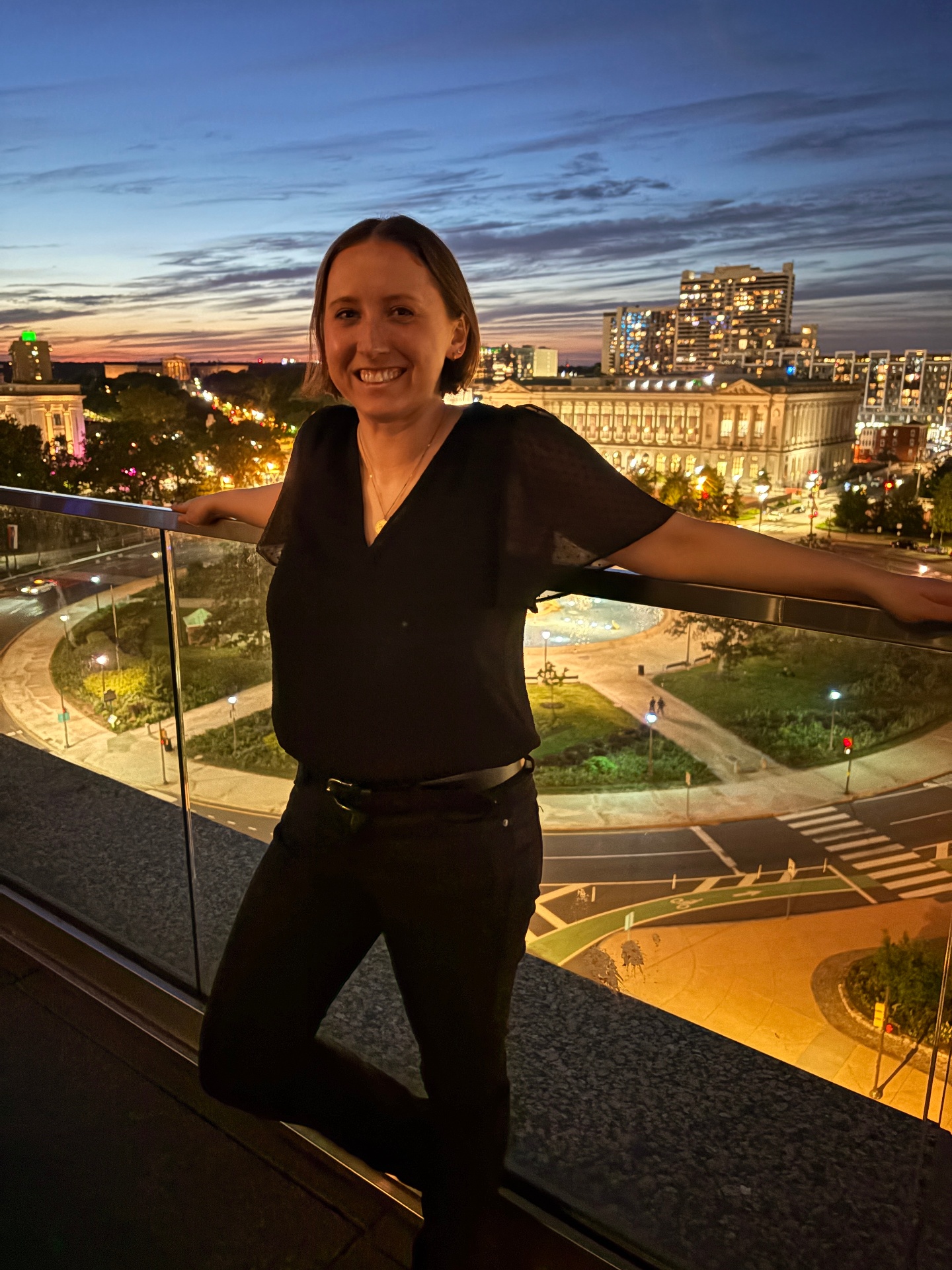 Kat Jost at a balcony overlooking Philadelphia at dusk